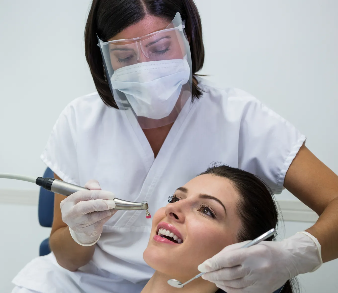 A dentist treating a patient in the chair
