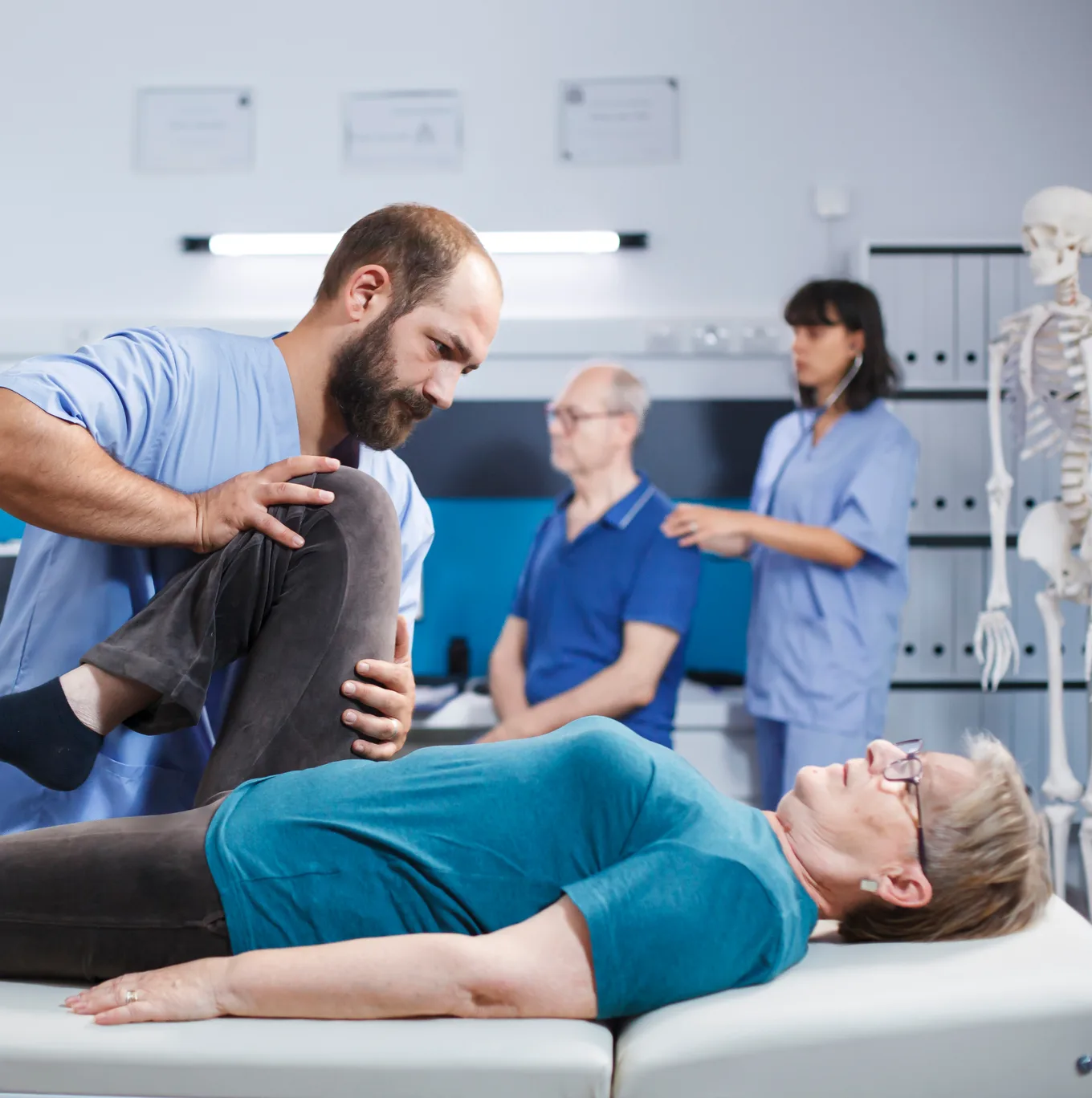 An orthopedic clinician guiding a patient through a knee mobility assessment